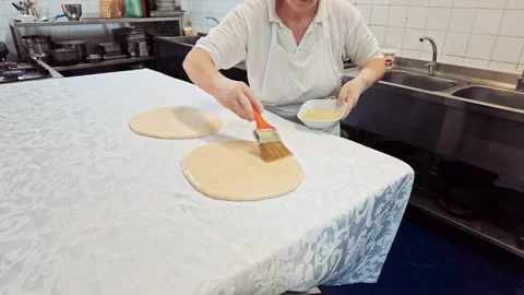 Cook lubricates the dough for placints pie with oil, Romanian and Moldovan Stock Footage 168648694