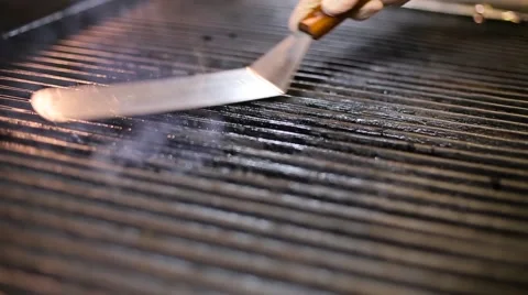 Cook lubricates a grill Stock Footage 67863670