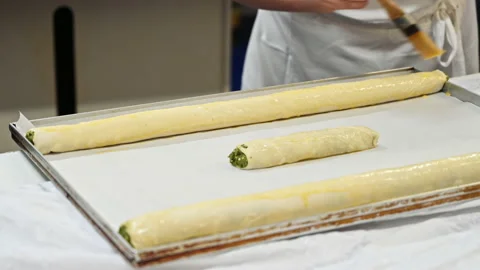 Cook lubricates raw placints pie with oil, Romanian and Moldovan Stock Footage 168647704