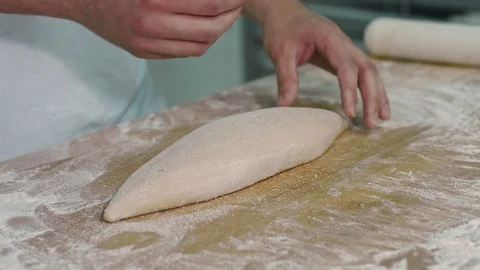 The cook make cuts by the help of blade on the dough Stock Footage 92580792