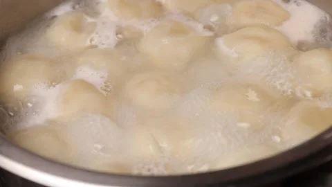 The cook make dumplings out of the pan Stock Footage 241925396