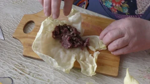 The cook makes cabbage rolls from cabbage and meat Stock Footage 148947056
