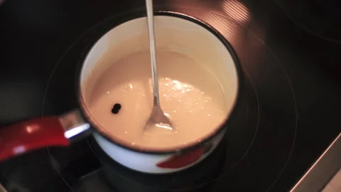 Cook makes a colored glaze for the cake Stock Footage 143782212