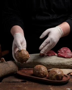 Cook makes cutlet with dark background Stock Photos