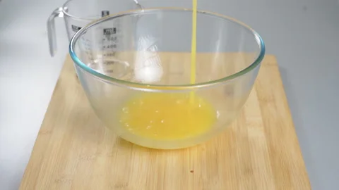 The cook makes dough with their eggs and flour. Whisk the egg yolk and white Stock Footage 232413381