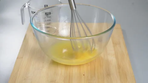 The cook makes dough with their eggs and flour. Whisk the egg yolk and white Stock Footage 232413743