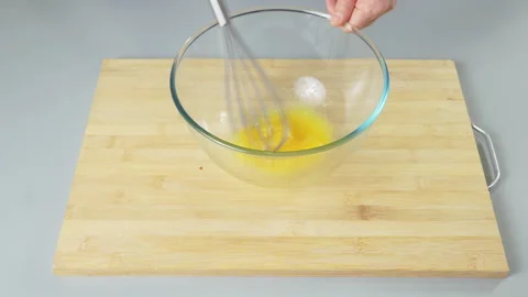 The cook makes dough with their eggs and flour. Whisk the egg yolk and white Stock Footage 232413818