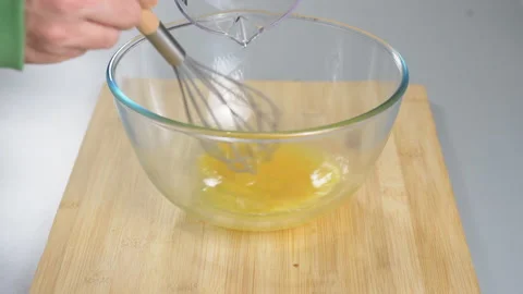 The cook makes dough from their eggs and flour. Adds sunflower oil. Gray Stock Footage 232413974