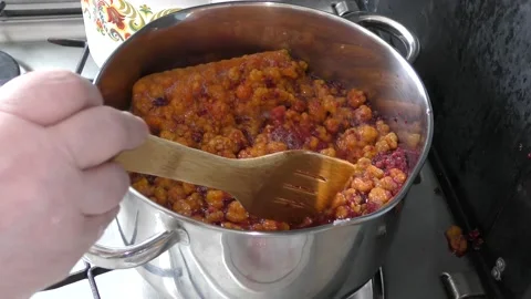 Cook makes jam from berries Stock Footage 136632337