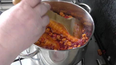 Cook makes jam from berries Stock Footage 136632863