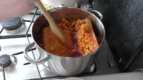 Cook makes jam from berries Stock Footage 136633290