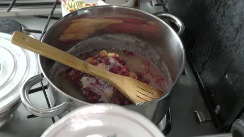 Cook makes jam from berries Stock Footage 136634087