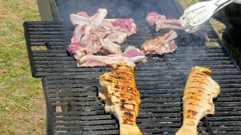 The cook makes meat and fish on the barbecue. Stock-Footage 85086858