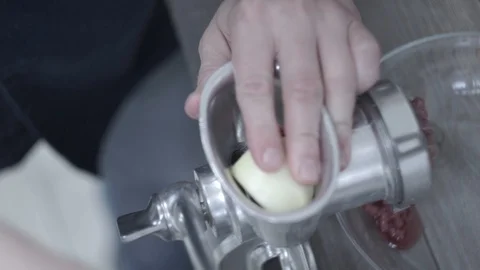 Cook makes minced meat with meat grinder Video stock 106631192