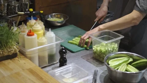 The cook makes preparations, cuts cucumbers Stock Footage 247020871
