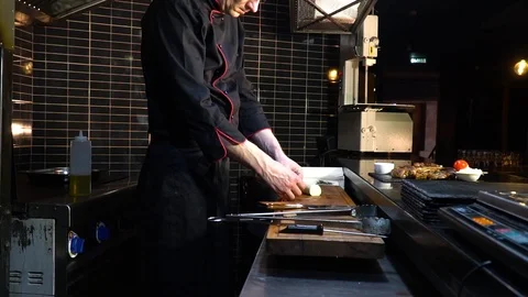 Cook makes roll of dough with curd filling, cuts into flat pieces, spreads on Stock Footage 85670478