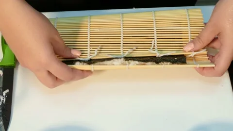The cook makes a roll with rice outside. Fast moving. Stock Footage 88494705