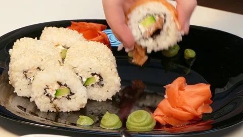 A cook makes a set of sushi rolls on a plate. Stock Footage 88430715