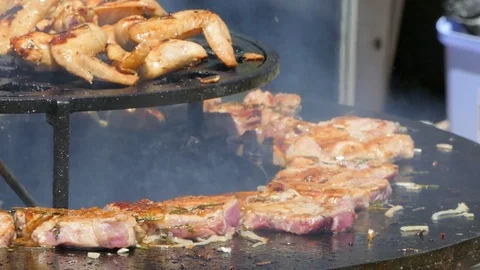 Cook makes steaks in the park on the grill Stock-Footage 85084439