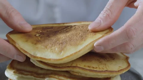 The cook makes a tower of the thick American pancakes. Slow motion video 100fps Stock Footage 263254144