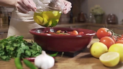 The cook makes vegetarian dish with hot broth and fresh vegetables, onion with Stock Footage 79042407