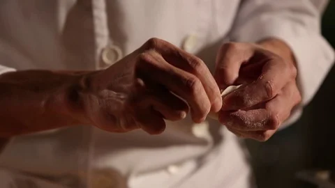 A cook is making dumplings with his hands. Stock Footage 70240255