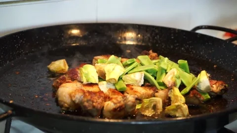 Cook making the green beans and artichokes to mix them with the meat in the p Stock Footage 147988758