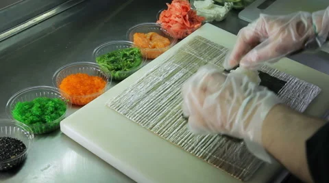 Cook making sushi rolls, spreading rice over nori 스톡 동영상 41944895