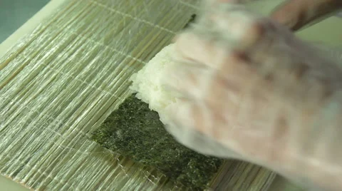 Cook making sushi rolls, spreading rice over nori 스톡 동영상 41951884