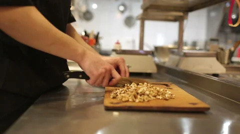 Cook man, chopped walnuts Stock Footage 48643707