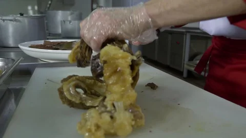 Cook man cuts cooked meat on a cutting table Stock Footage 88898481