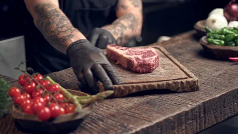 Cook man lay on the table raw steak.  Stock Footage 151466953