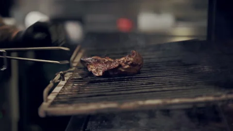 Cook man taking ready piece of steak from the grill in the restaraunt. Video stock 151468247