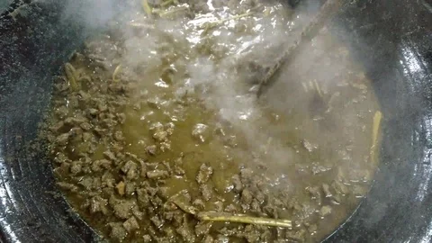 Cook meat in a large pan 2. Full HD Stock Footage 92235885