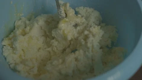 Cook mixes cottage cheese with egg in a plate. homemade cooking Stock Footage 133122917