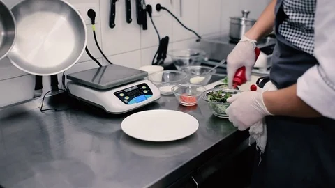 The cook mixes a salad on a kitchen in the restaurant Stock Footage
