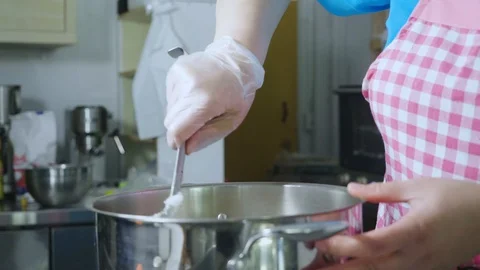 A cook mixing everything inside a big pot Stock Footage 129993413