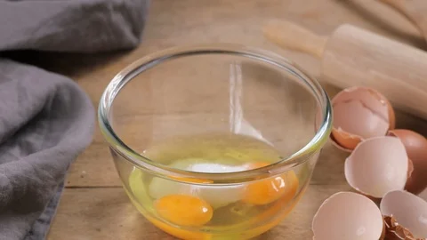 Cook mixing raw eggs with sugar in glass bowl Stock Footage 101991469