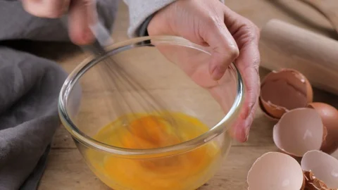 Cook mixing raw eggs with sugar in glass bowl Stock Footage 101991600