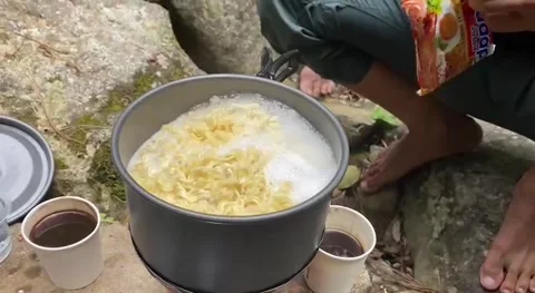 Cook noodles at sendang waterfall Stock Footage 239598020