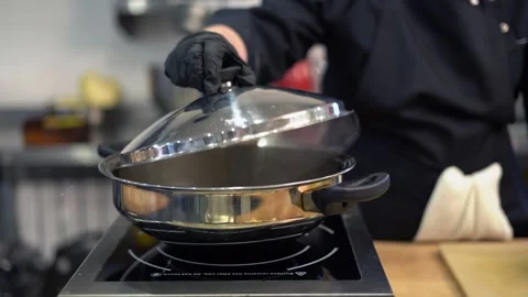 The cook opens the pan, beautiful steam. Stock Footage 159366183