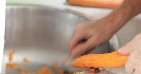 Cook peeling off carrot, close-up Stock Footage 170448729