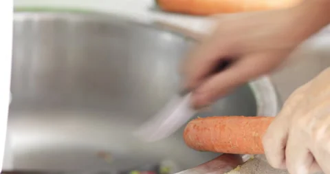 Cook peeling off carrot, close-up Stock Footage 170448803