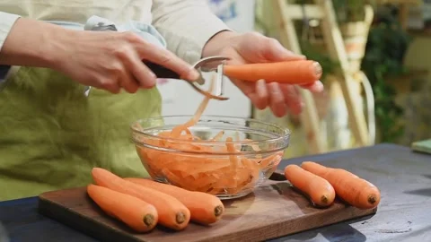 The cook is peeling the carrot. Stock Footage 249938516