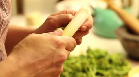 Cook peeling leek in the kitchen Stock Footage 47210677