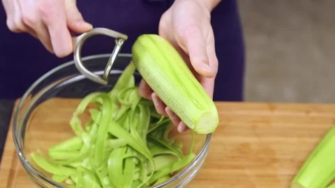 The cook peels a courgette. Stock Footage 152529187