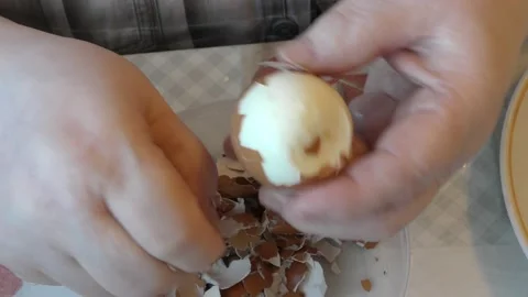 The cook peels the egg from the shell Stock Footage 194156220
