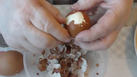The cook peels the egg from the shell Stock Footage 194156272