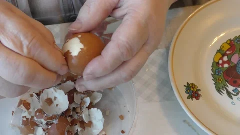 The cook peels the egg from the shell Stock Footage 194156414
