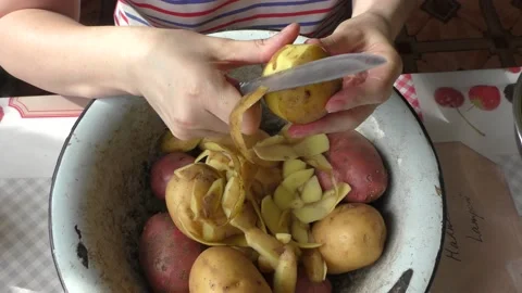 The cook peels the potatoes Stock Footage 154846770